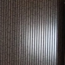 Close-up of the espresso fluted panel on site.