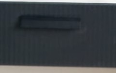 Close-up: charcoal fluted drawer fronts.